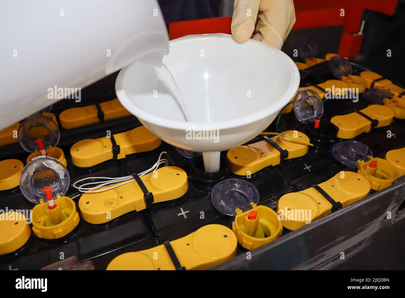 Adjust the battery distilled water level Stock Photo Alamy