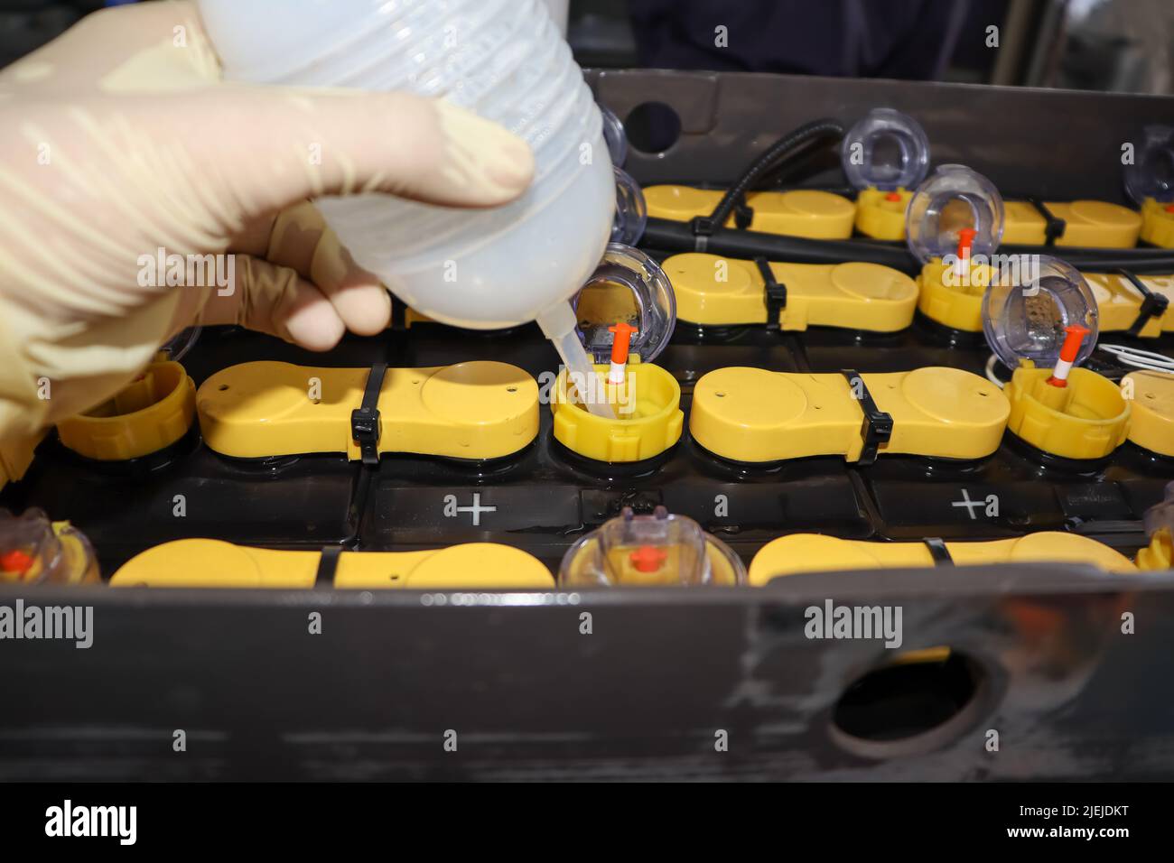 Adjust the battery distilled water level Stock Photo Alamy