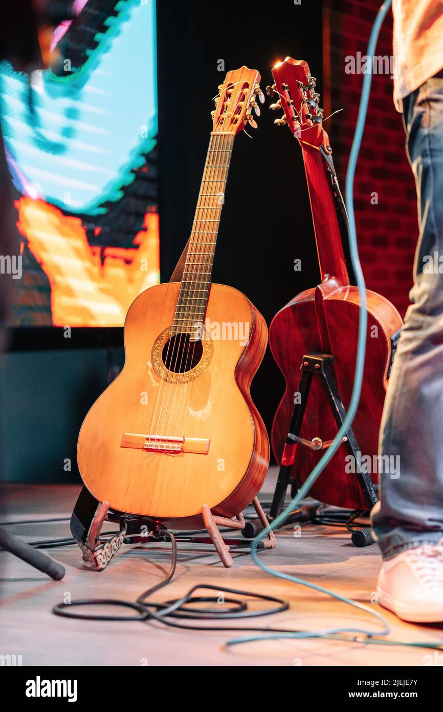 Two acoustic guitars on a guitar stand Stock Photo Alamy