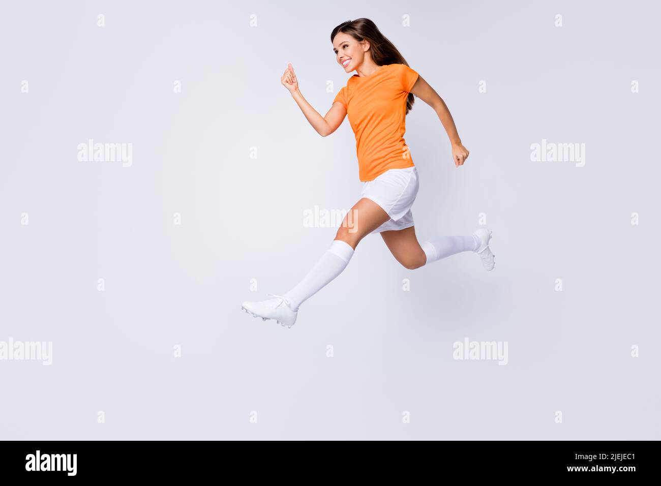 Full body profile photo of excited lady player soccer jump high running