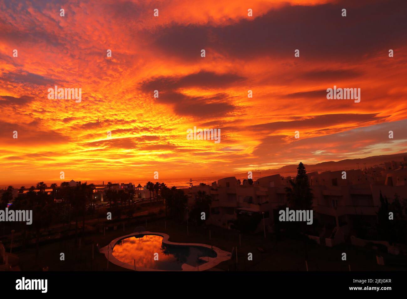Sunset of red sky with cloudy and reflection on the sea Stock Photo - Alamy
