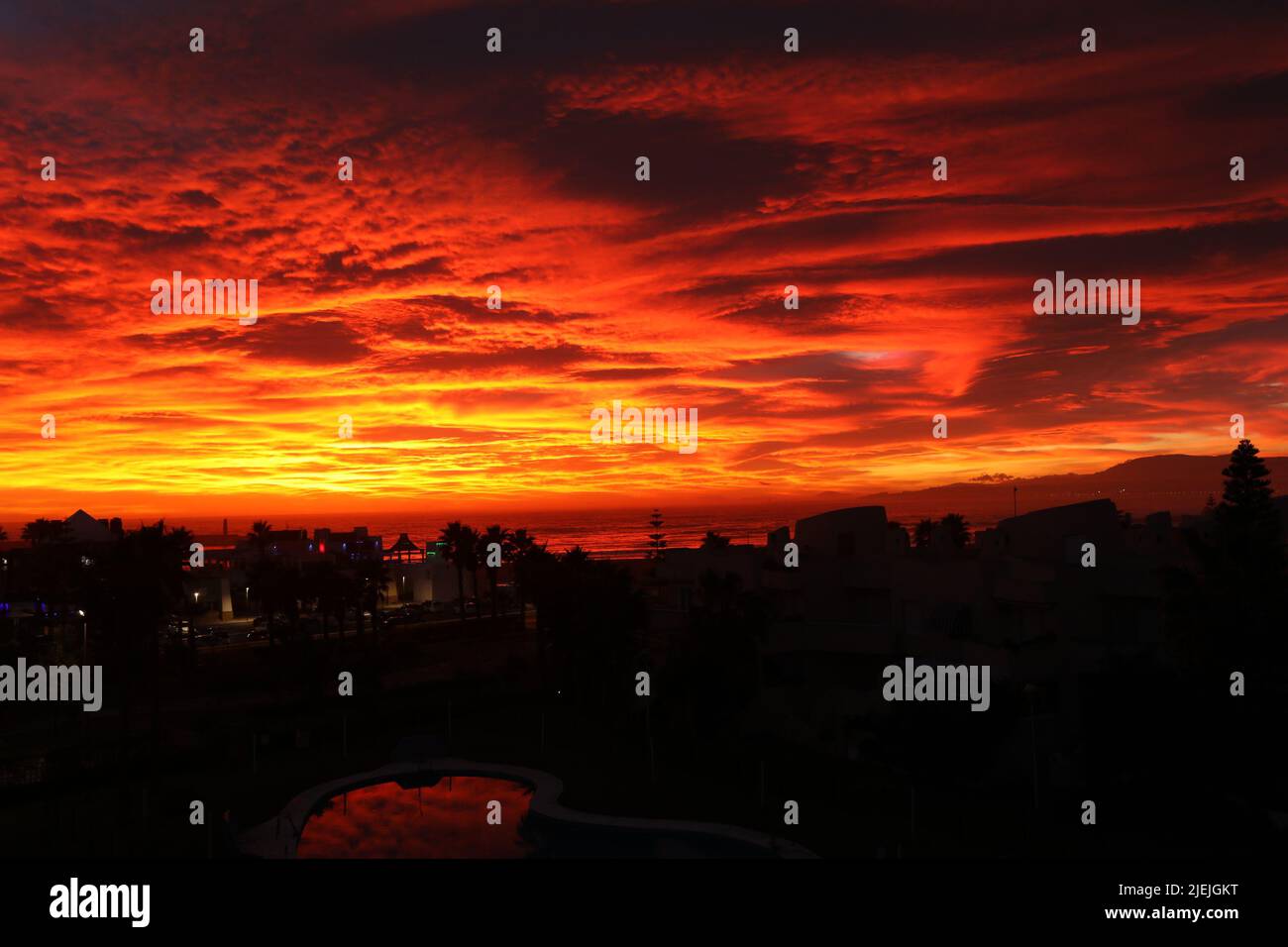 Sunset of red sky with cloudy and reflection on the sea Stock Photo - Alamy