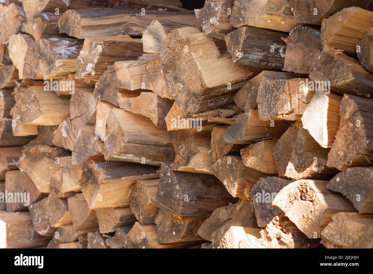 Folded stack of chopped drying log firewood Stock Photo
