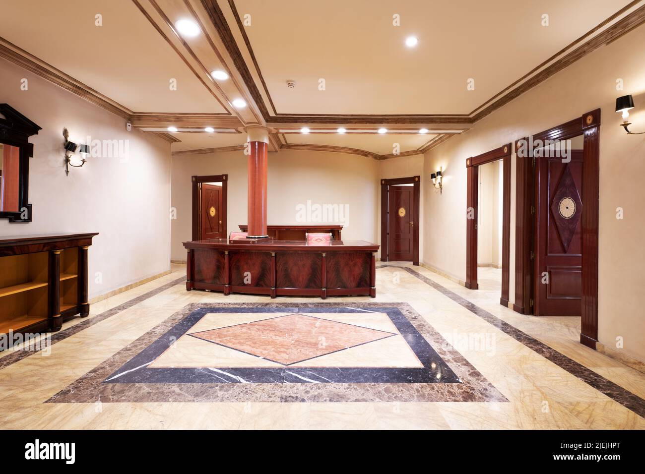 Reception desk of a professional office with hardwood doors and furniture and marble floors