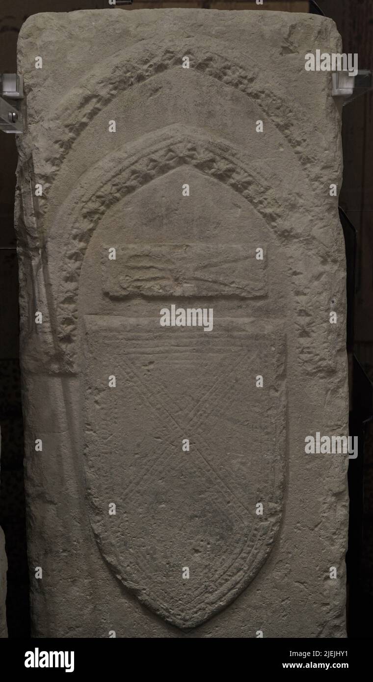 Detail of a medieval tombstone belonging to one of the ancient tombs of a cemetery, which no longer exists, located near the church of St Augustine at Rabat (Victoria) on the island of Gozo, Malta. According to tradition, the tombstones marked the graves of illustrious personages, civil and ecclesiastic, who accompanied King Louis IX of France in his crusade against Tunis in 1270. The returning French ships were scattered by a storm. Some of their crews also died of disease. Several ships arrived in the port of Gozo, where the dead were buried. Gozo Museum of Archaeology. Cittadela of Victoria Stock Photo