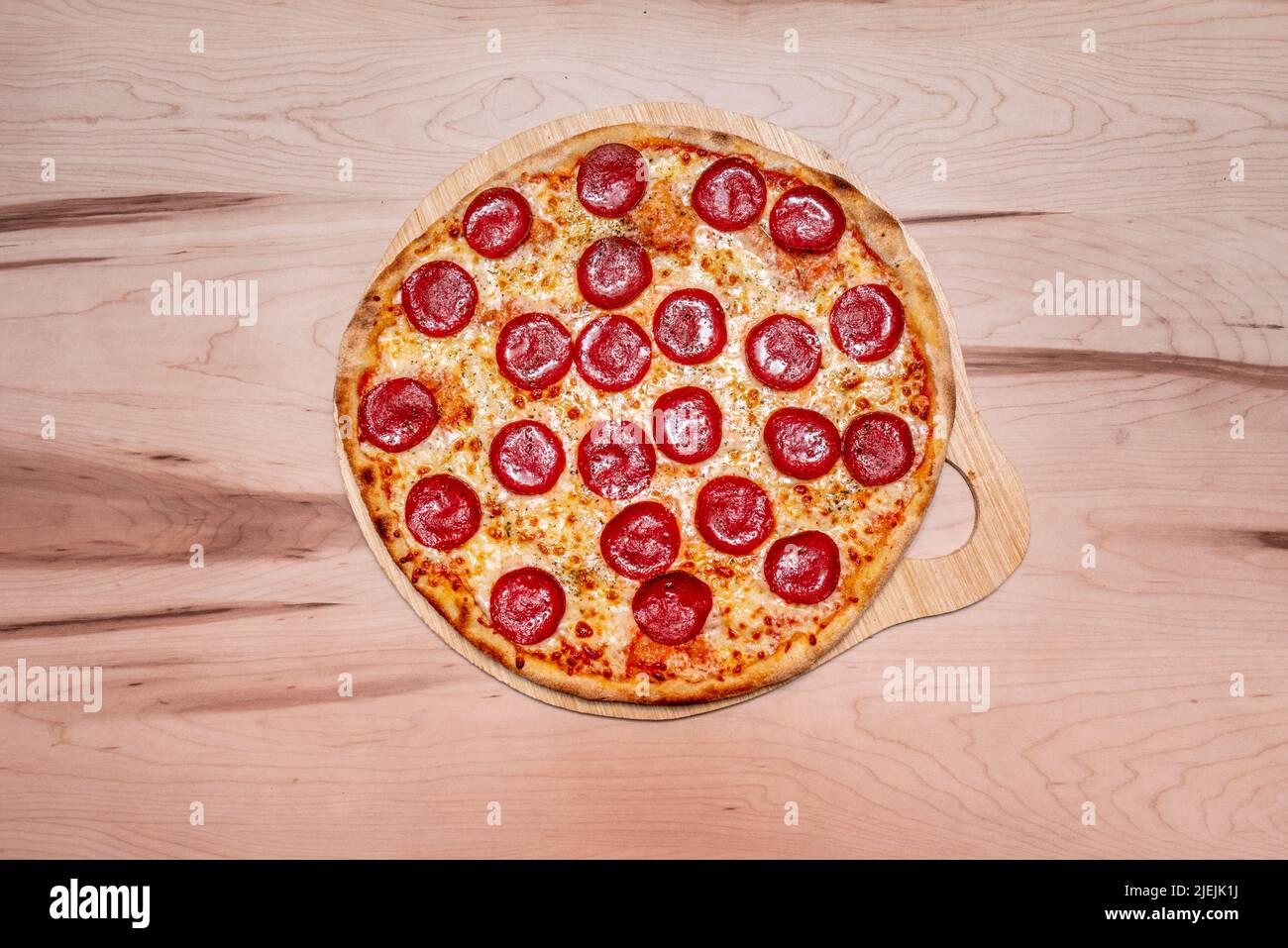 Great baked spicy pepperoni pizza with pepper, mozzarella cheese and