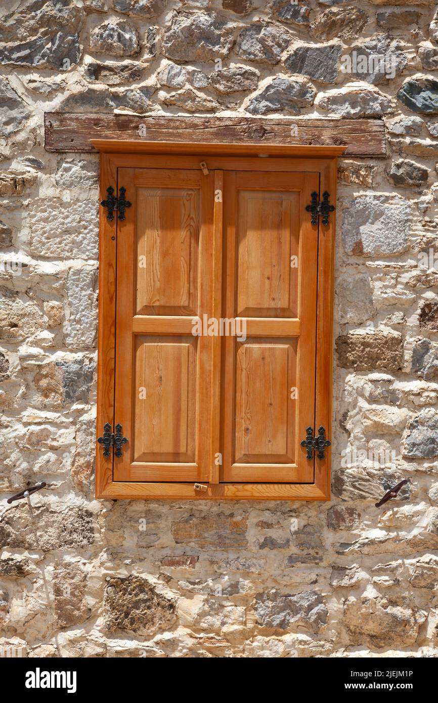 Closed wooden windows and shutters in the stonewall. Wooden windows in ...