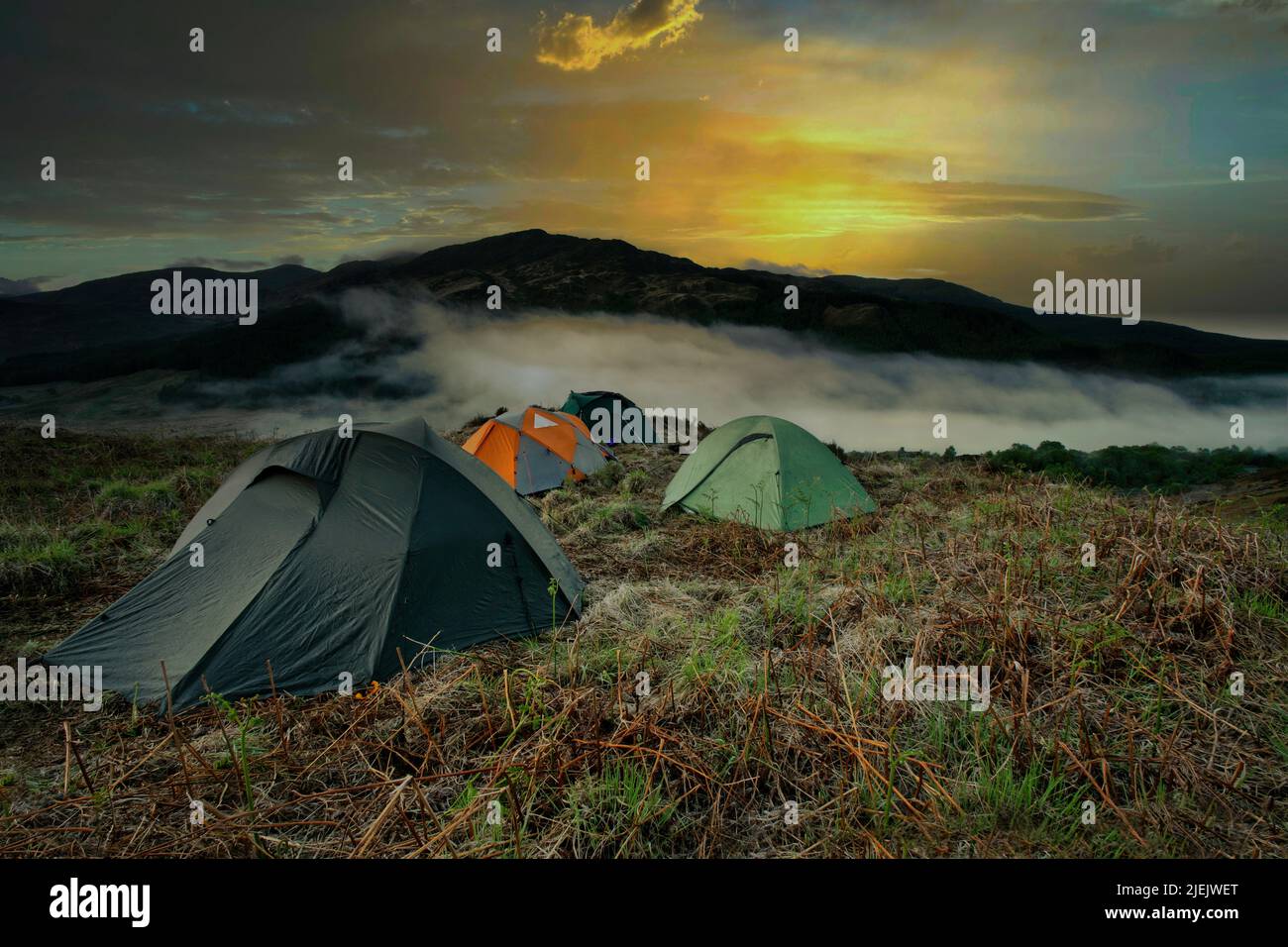 Wild Camping in the Scottish Mountains above the clouds at sunset Stock ...