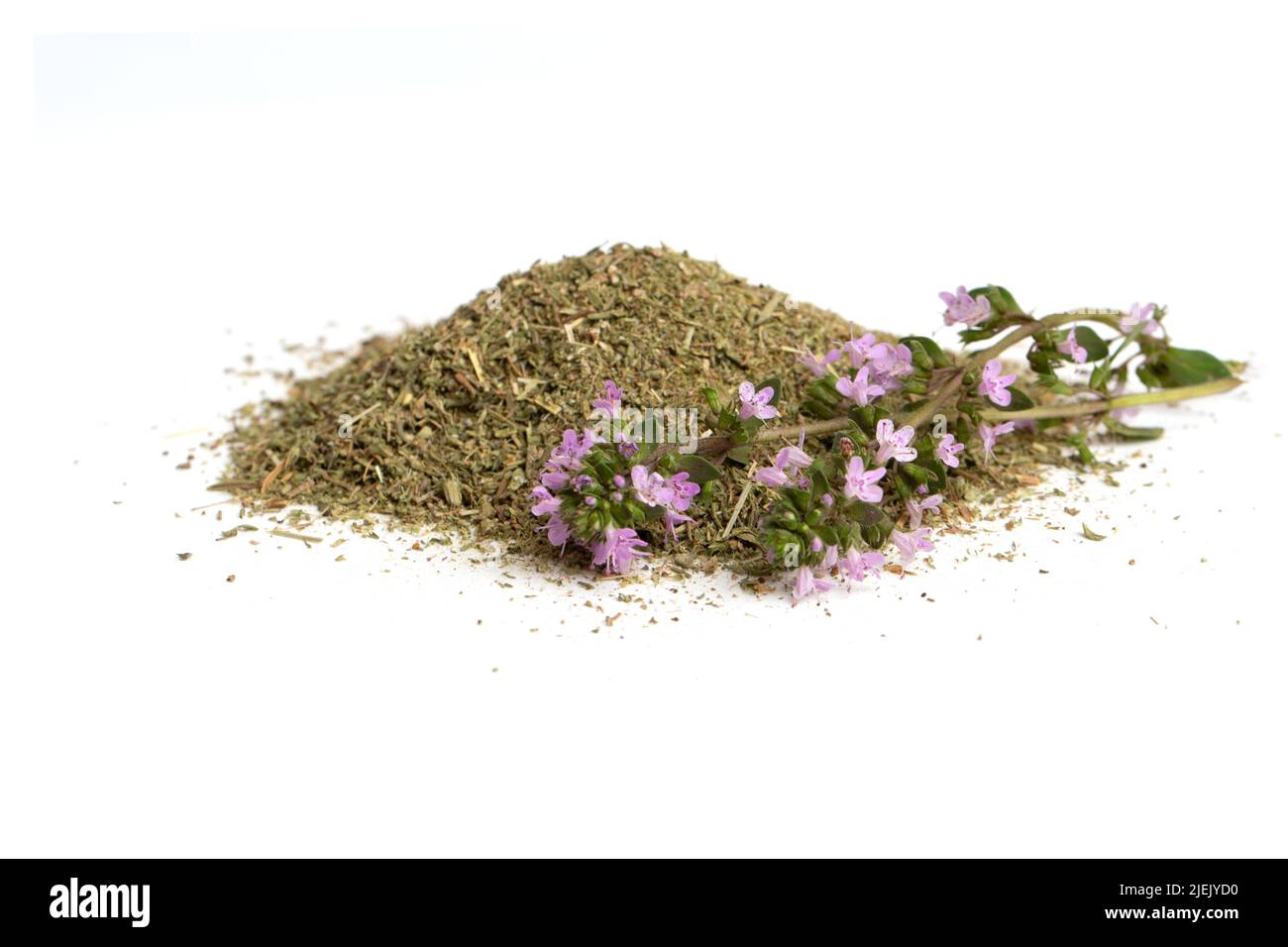 A hill of dried thyme grass and a flowering branch of a medicinal thyme