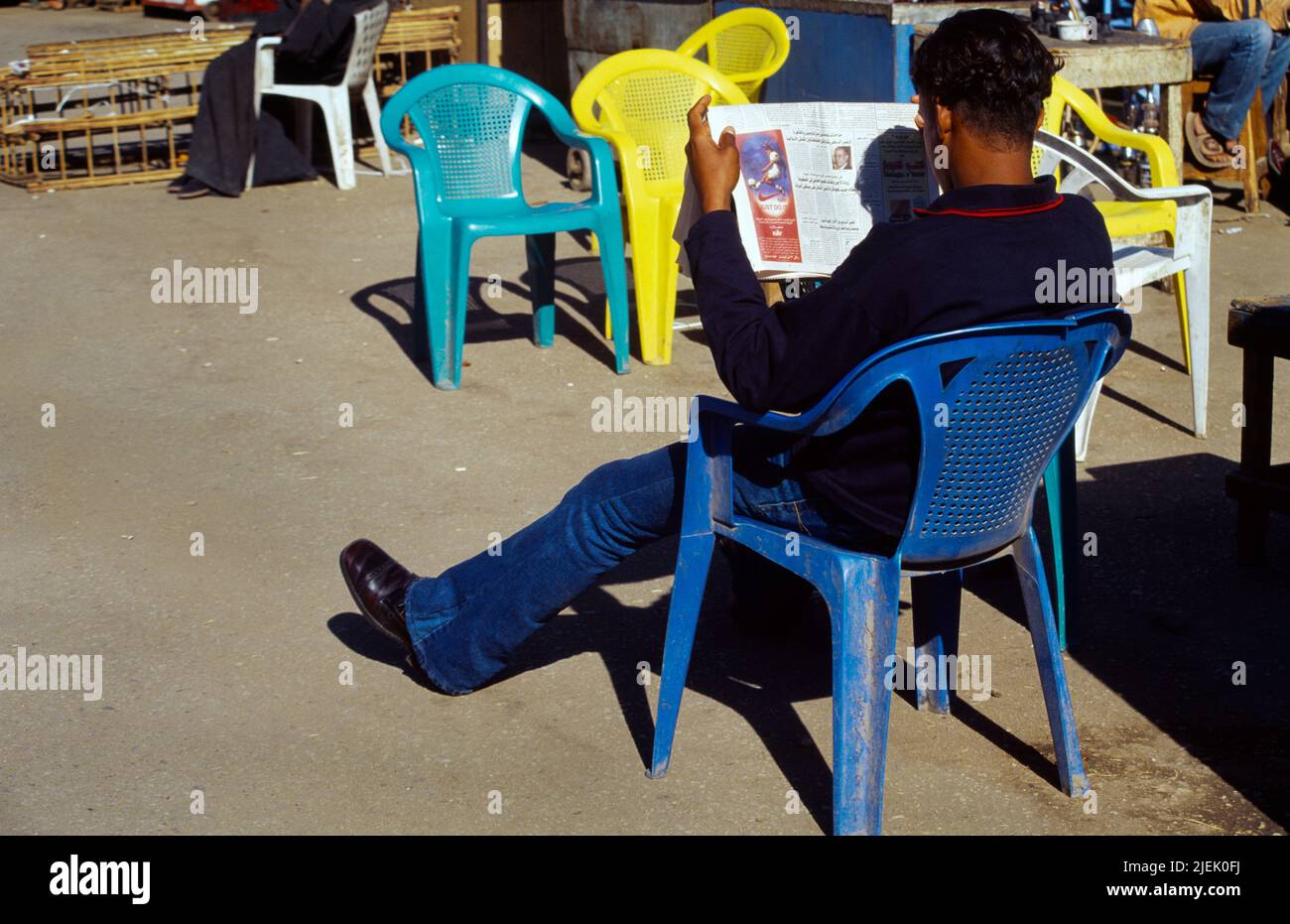 Luxor Egypt West Bank Ferry Station Young Man Reading Newspaper in Western Dress Stock Photo