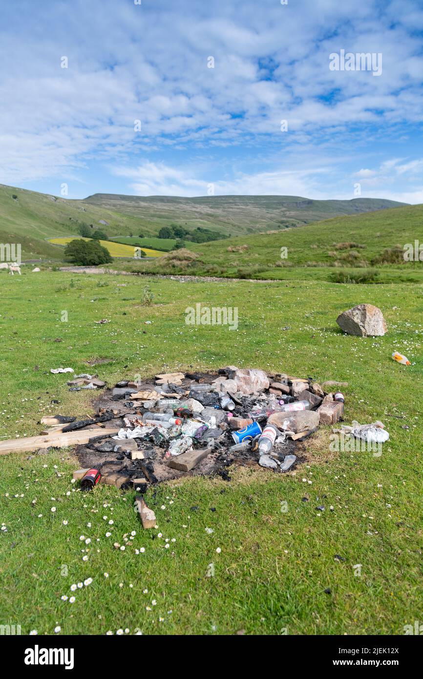 Rubbish left in countryside after campers have left their litter after wild camping in the Eden Valley, Cumbria, UK. Stock Photo