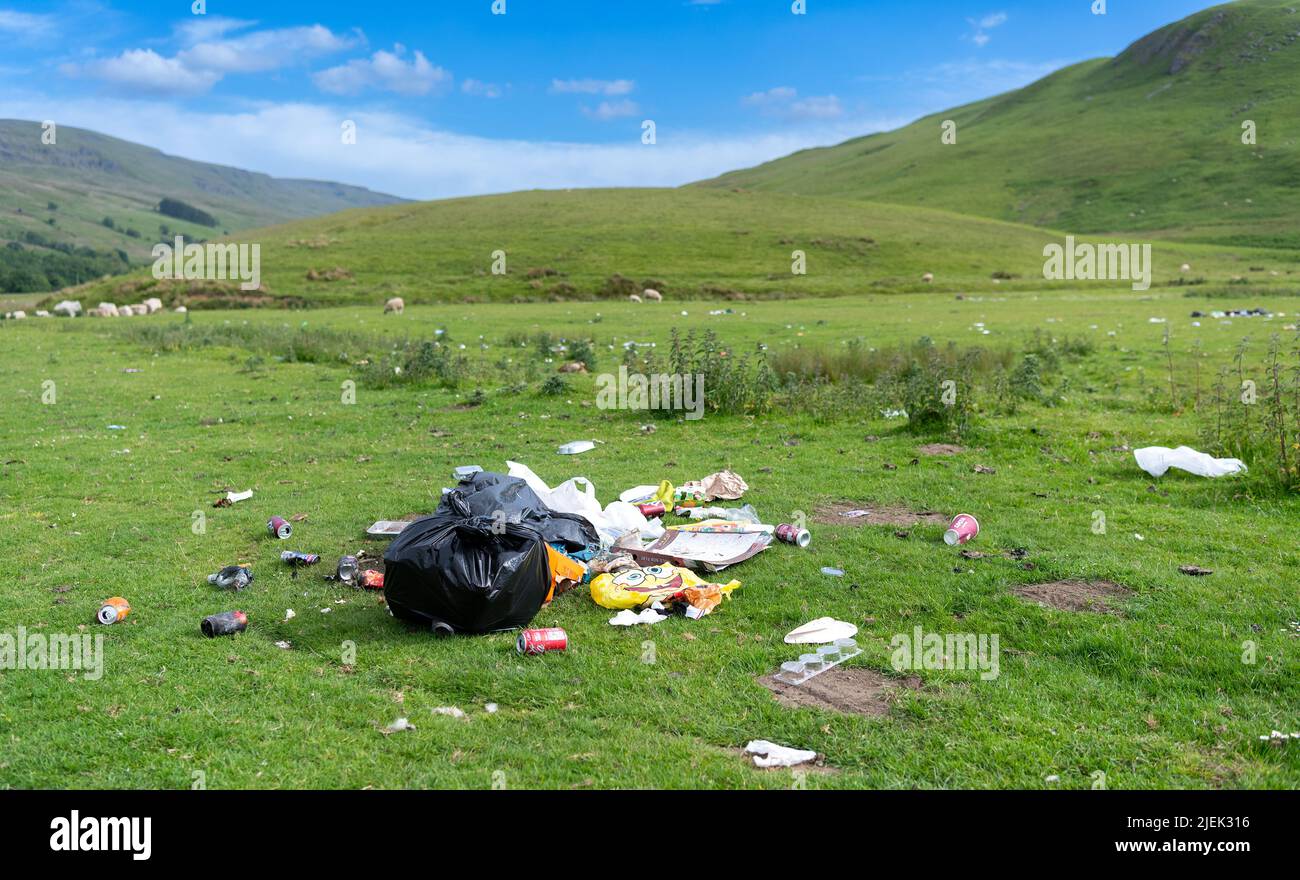 Rubbish left in countryside after campers have left their litter after wild camping in the Eden Valley, Cumbria, UK. Stock Photo