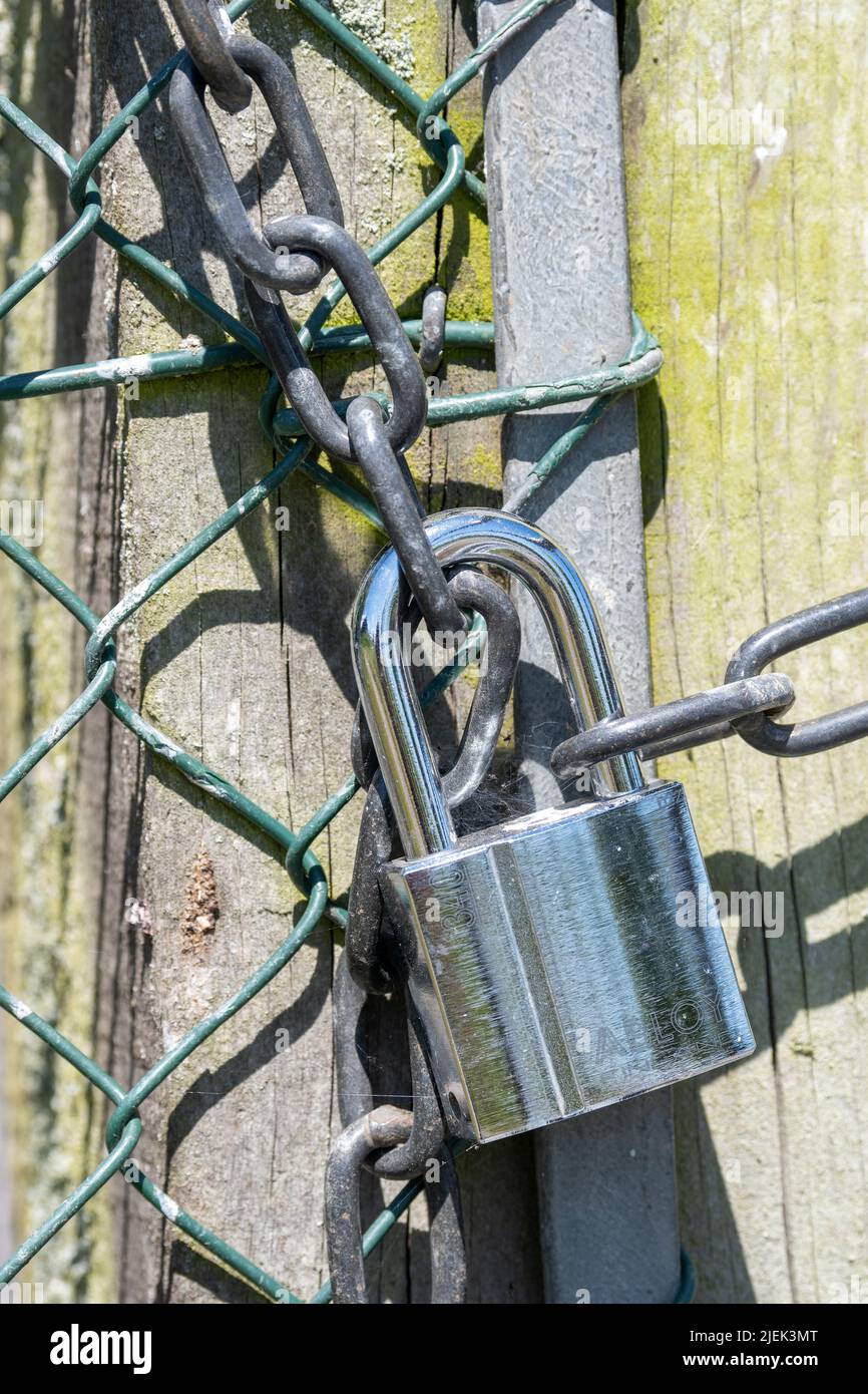 Gates fastened securely with a heavy duty padlock. North Yorkshire, UK. Stock Photo