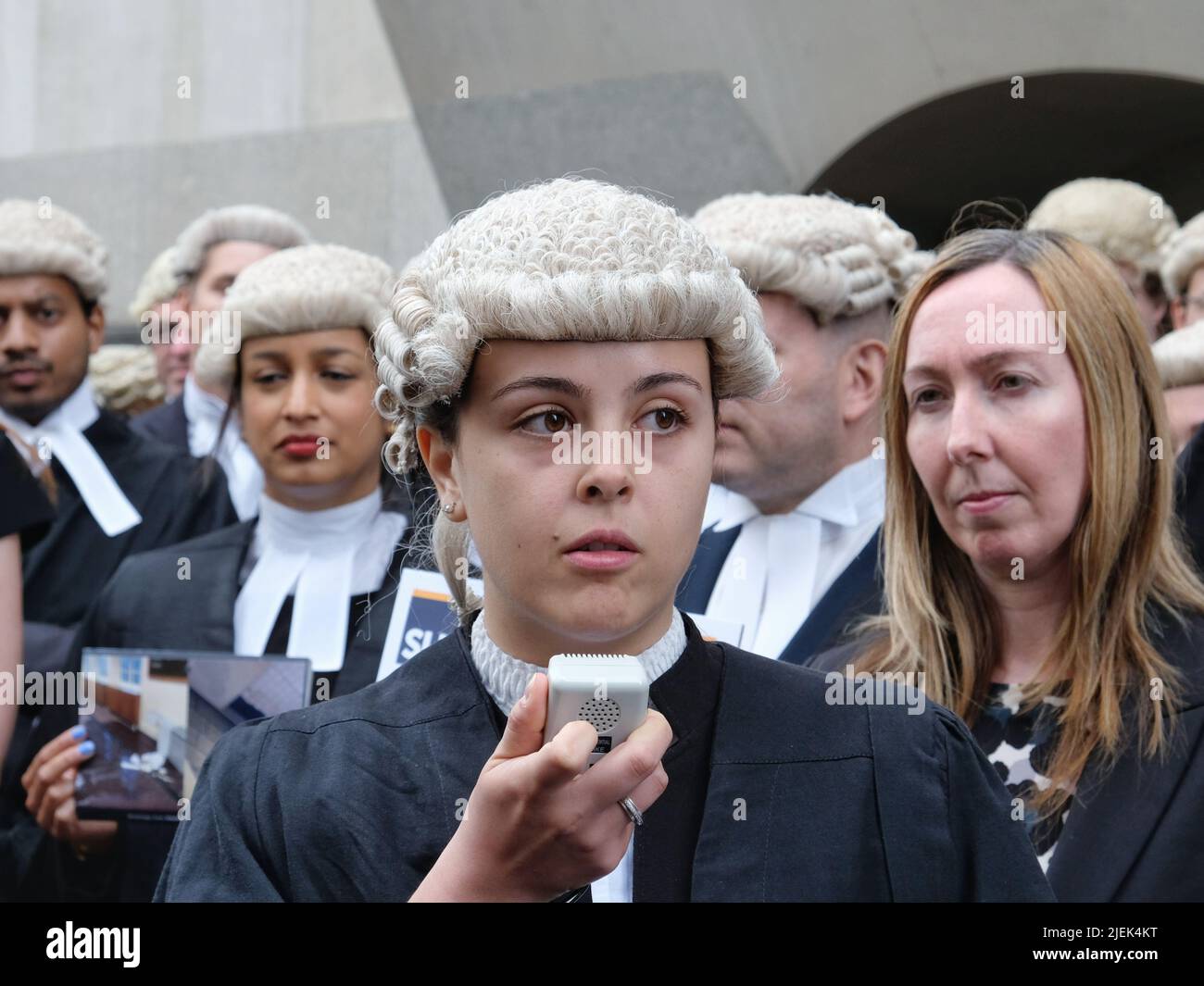 London, UK, 27th June, 2022. Alejandra Llorente Tascon addresses the crowd gathered outside the Old Bailey as criminal barristers across England and Wales begin strike action over legal aid payments. Hundreds of barristers and solicitors joined the picket outside the Central Criminal Court, also known as the Old Bailey in strike action today and tomorrow this week, and set to continue for a month. Credit: Eleventh Hour Photography/Alamy Live News Stock Photo