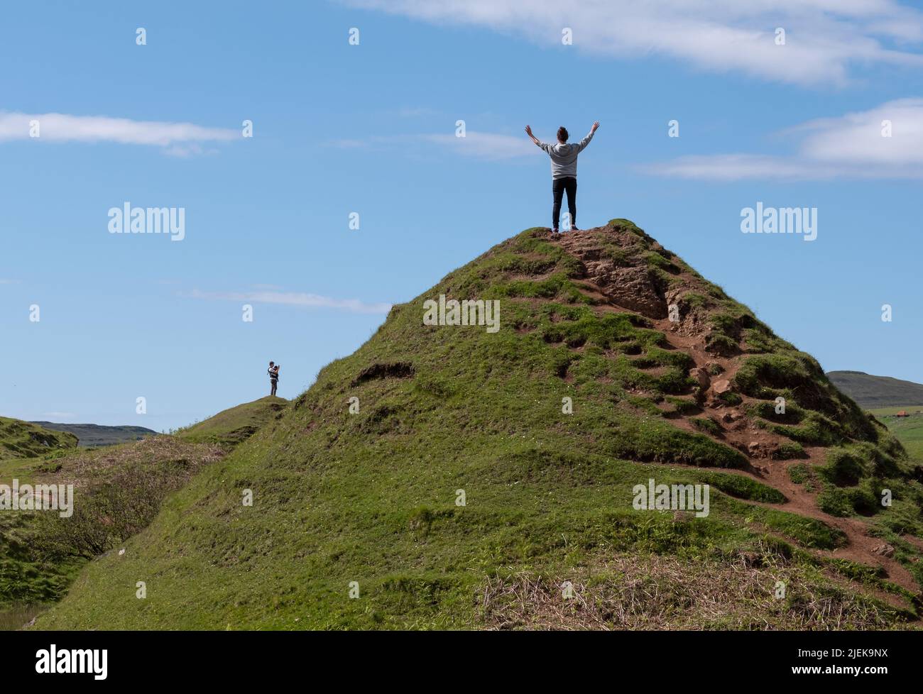 Tourists at Fairy Glen on Trotternish Peninsula. Varied landscape with hills, valleys and basalt cliffs in  north of Skye. Area suffers overtourism. Stock Photo