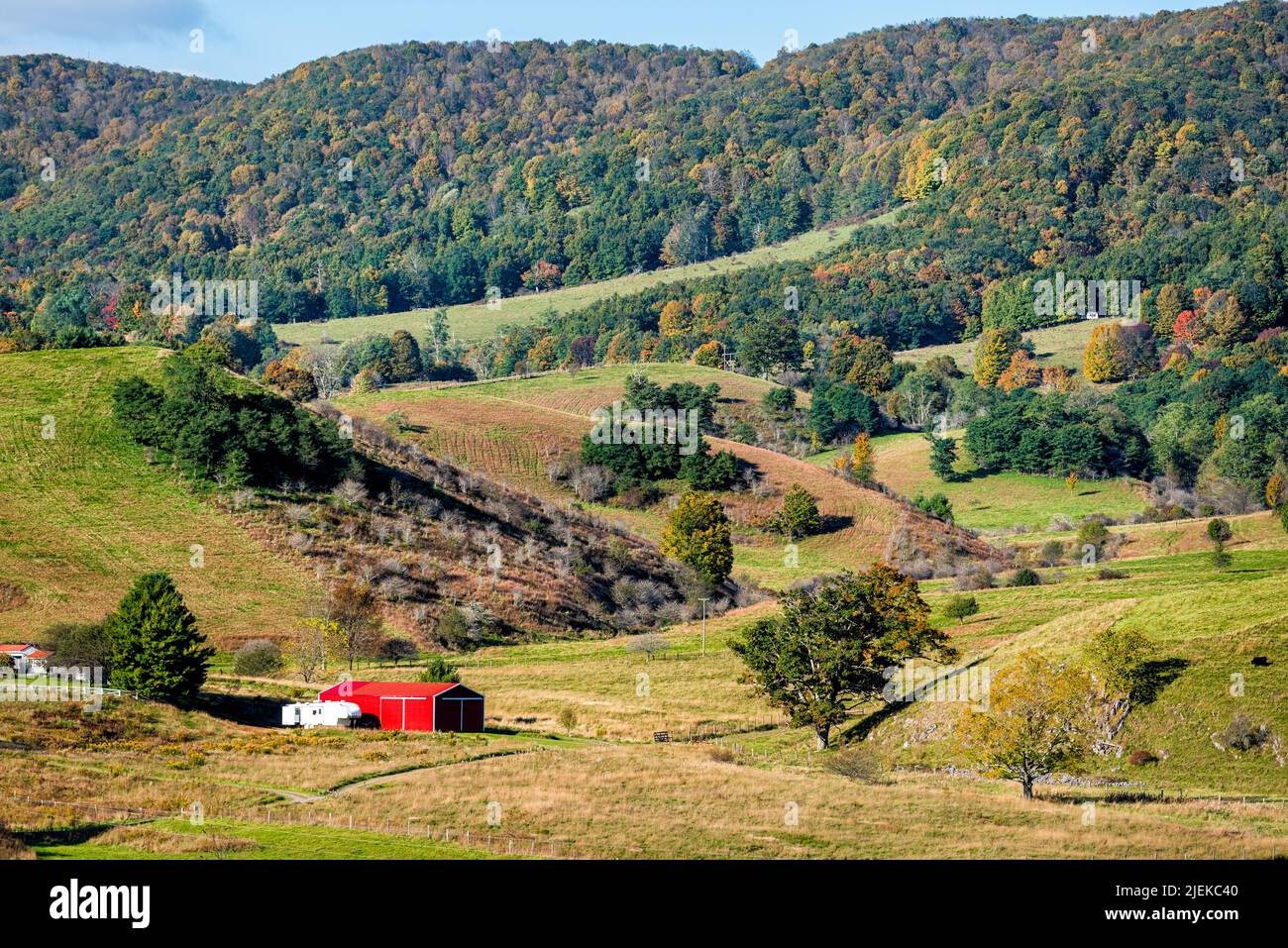 View of red farmhouse shed vibrant color in appalachian mountains in Highland County, Virginia