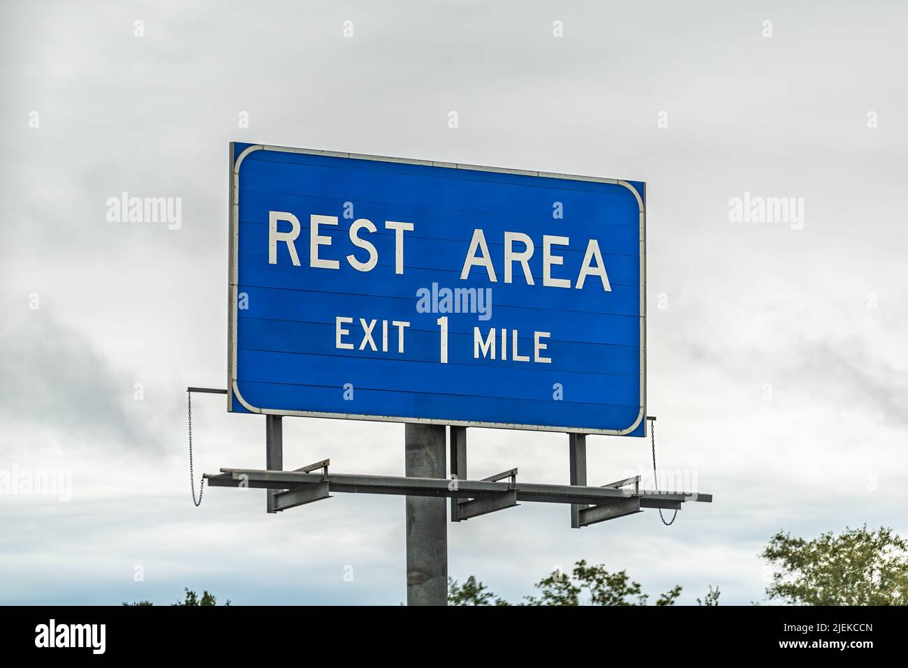 Blue color sign isolated closeup for rest area stop right exit in one mile in Sparks, south Georgia on interstate highway 75 with cloudy sky in backgr Stock Photo
