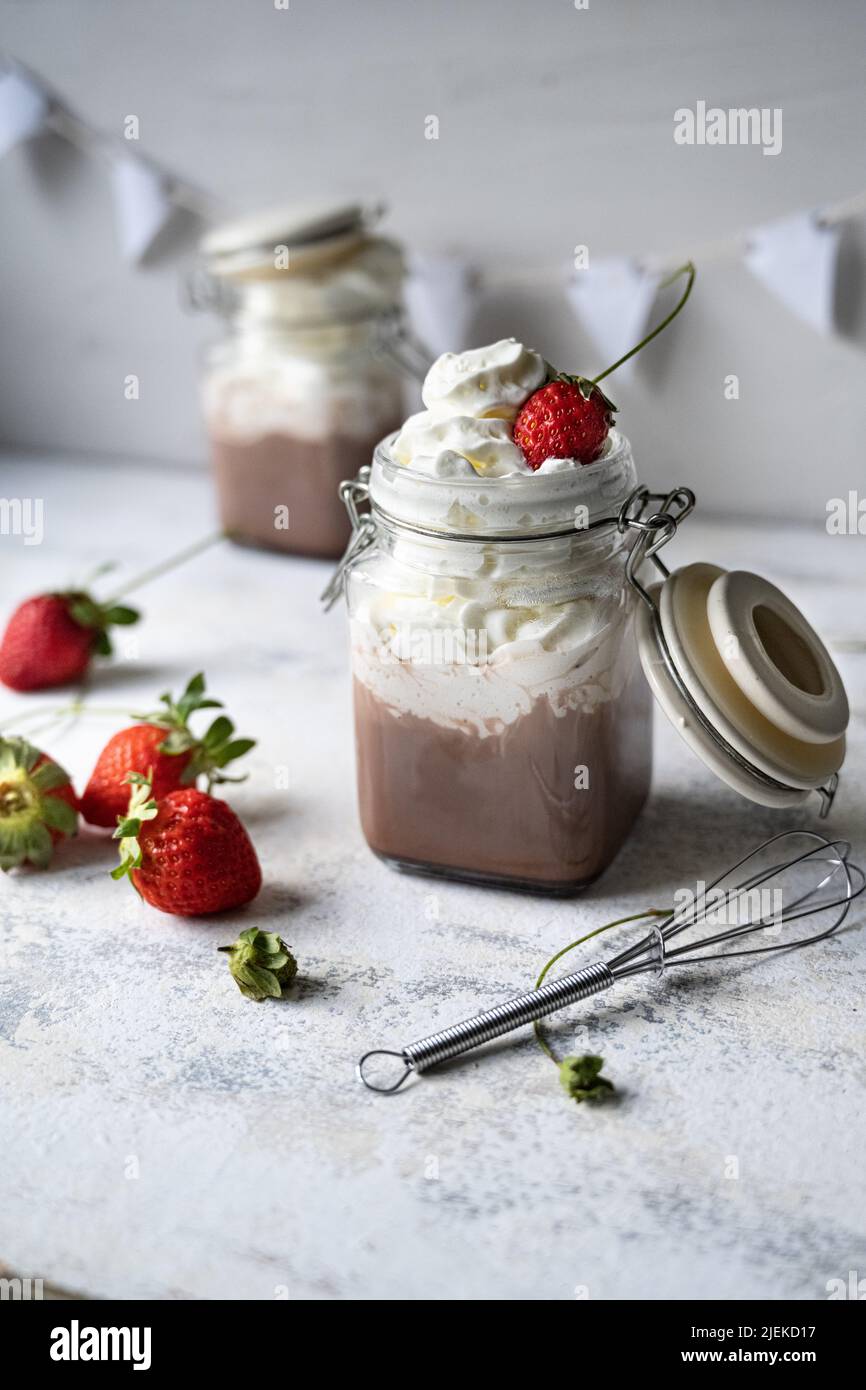Breakfast hot chocolate with fresh cream.Healthy milk and sweet strawberries. White background Stock Photo