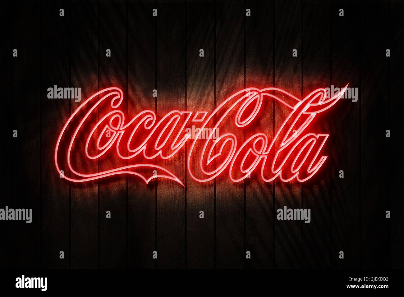 SWINDON, JUNE 2022. Coca cola neon sign on a Dark Wooden Wall 3D illustration. Stock Photo