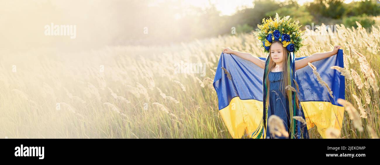 Ukraines Independence Flag Day. Constitution day. Ukrainian child girl with yellow and blue flag of Ukraine in field. flag symbols of Ukraine. Kyiv, Kiev day Stock Photo