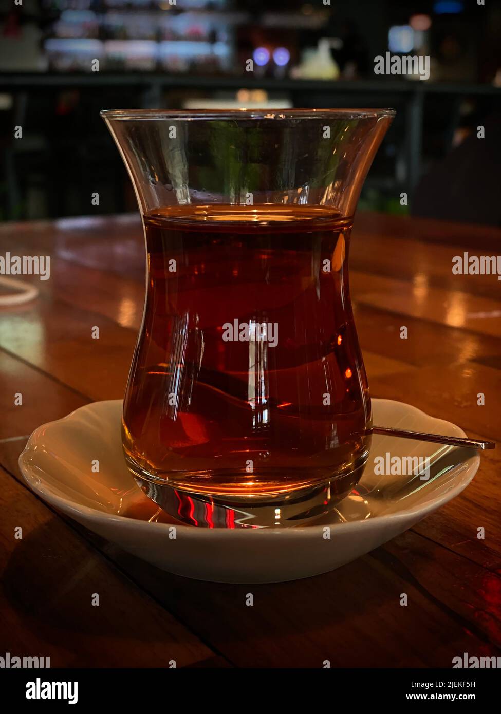 Traditional Turkish tea in a glass, on a white saucer, closeup, blur background Stock Photo Alamy