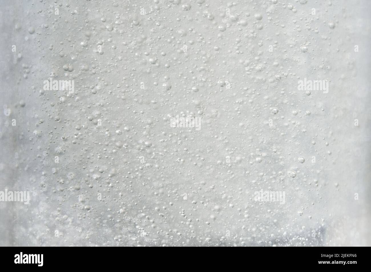 Bubbles in liquid gel on light grey background. Authentic makeup texture Stock Photo