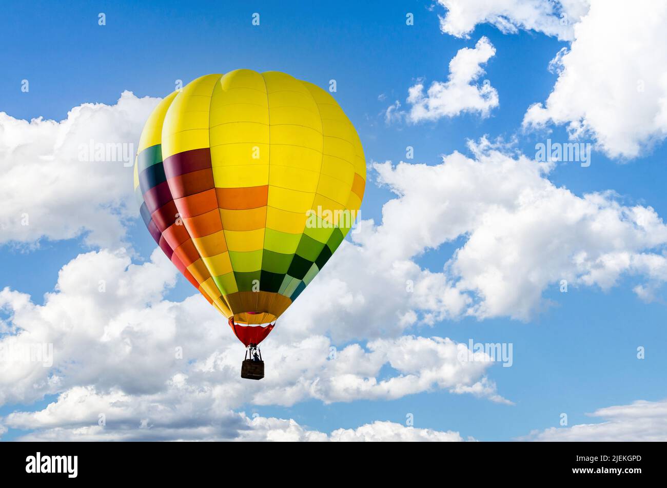 Colorful hot air balloon flying over blue sky Stock Photo - Alamy