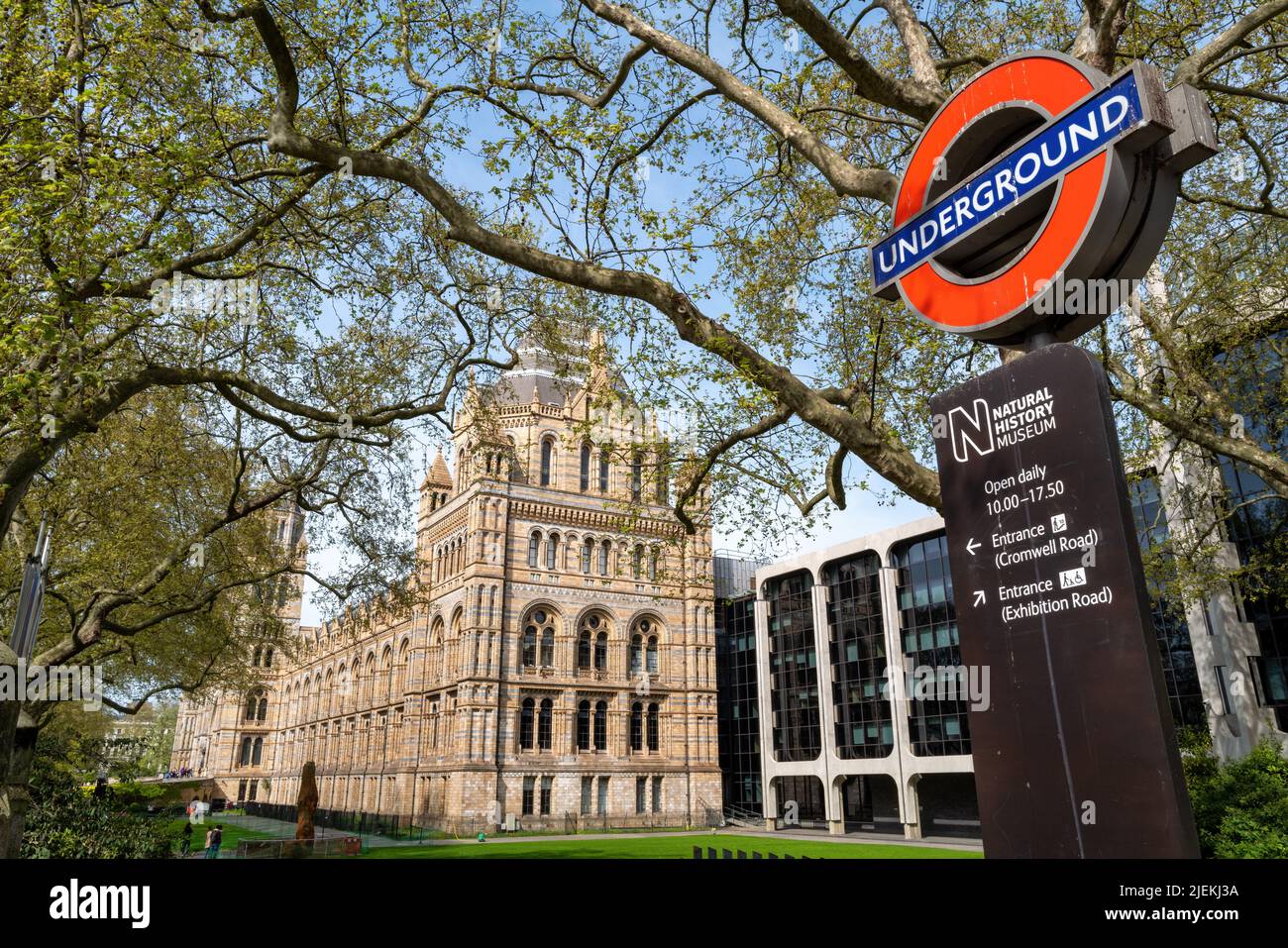 London, UK - 17th April 2022: Exterior of the Natural History Museum with London Underground sign and information board. Stock Photo