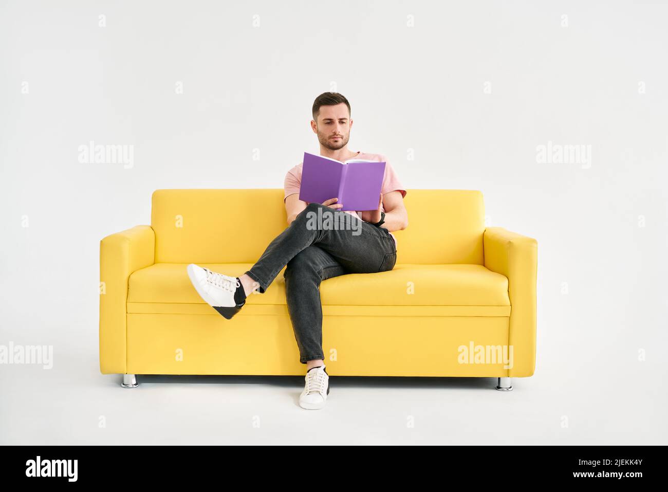 Man relaxing on sofa reading book. Rest, Hobby concept Stock Photo