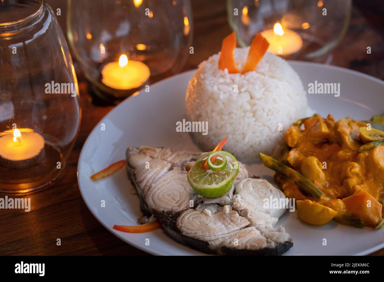 Traditional grilled Fish with lime garnish and rice with vegetables. Picture: garyroberts/worldwidefeatures.com Stock Photo
