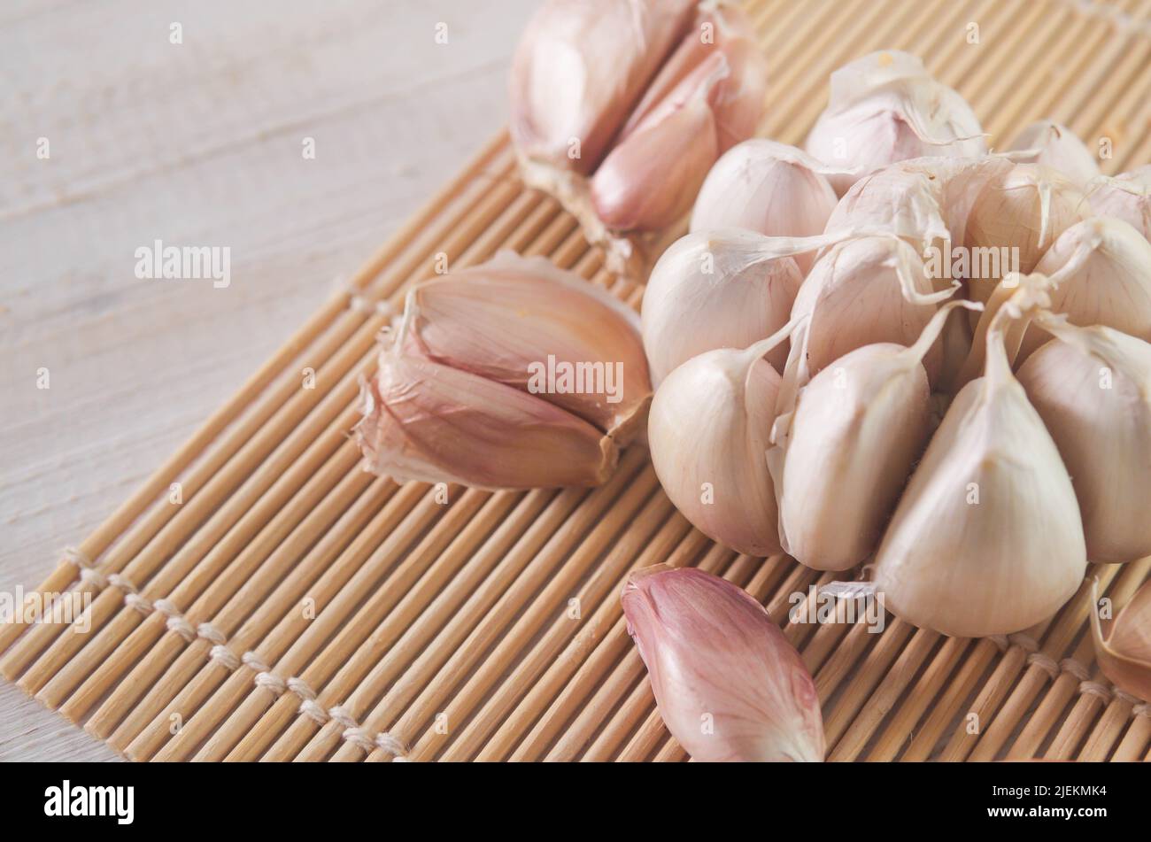 garlic on a wooden board in selective focus Stock Photo