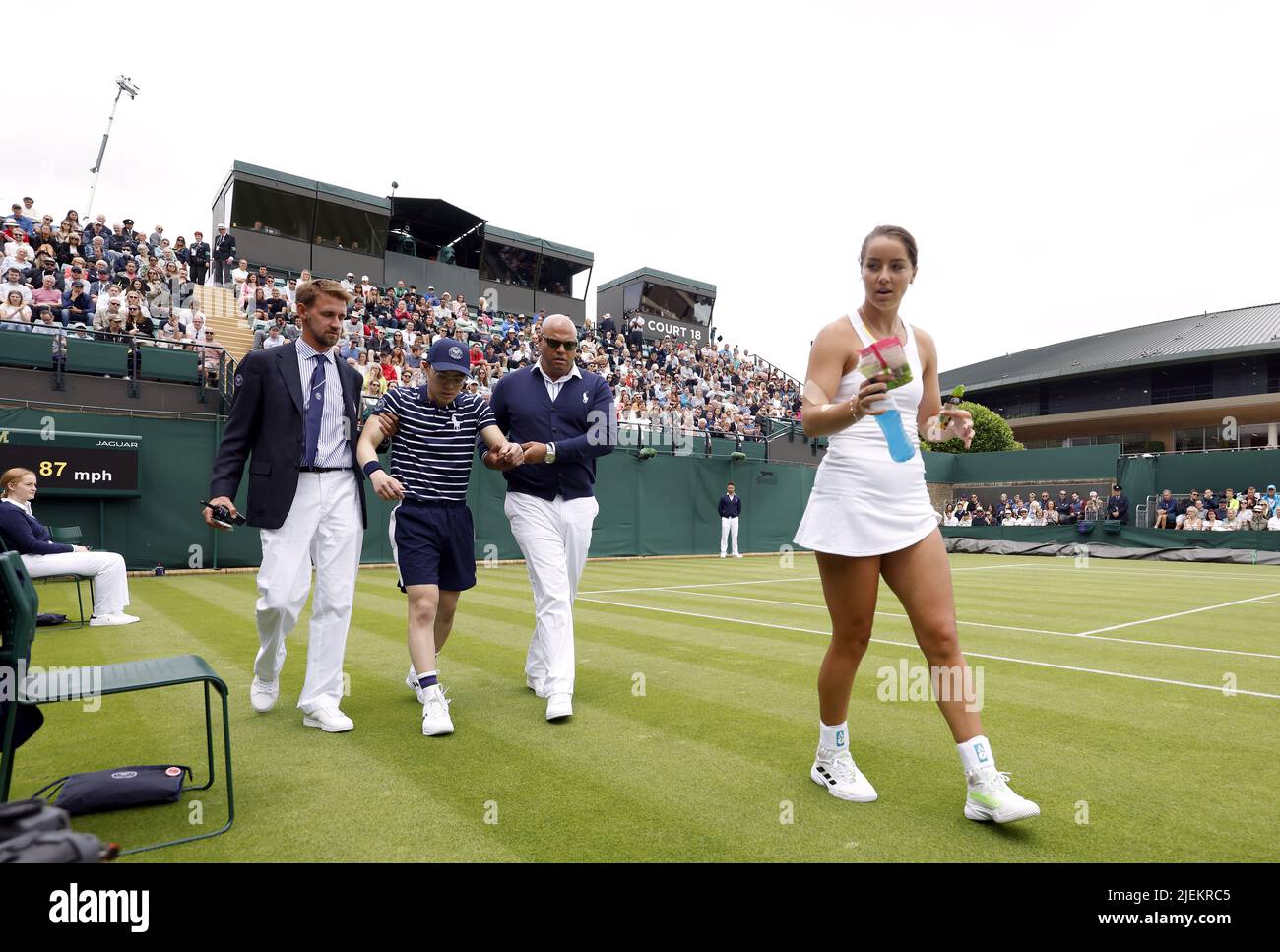 File photo dated 27-06-2022 of a ball boy helped off court at Wimbledon. Jodie Burrage (right) had no hesitation in handing out Percy Pig sweets to the ball boy who had fallen ill during her first-round defeat to Lesia Tsurenko. Issue date: Monday June 27, 2022. Stock Photo