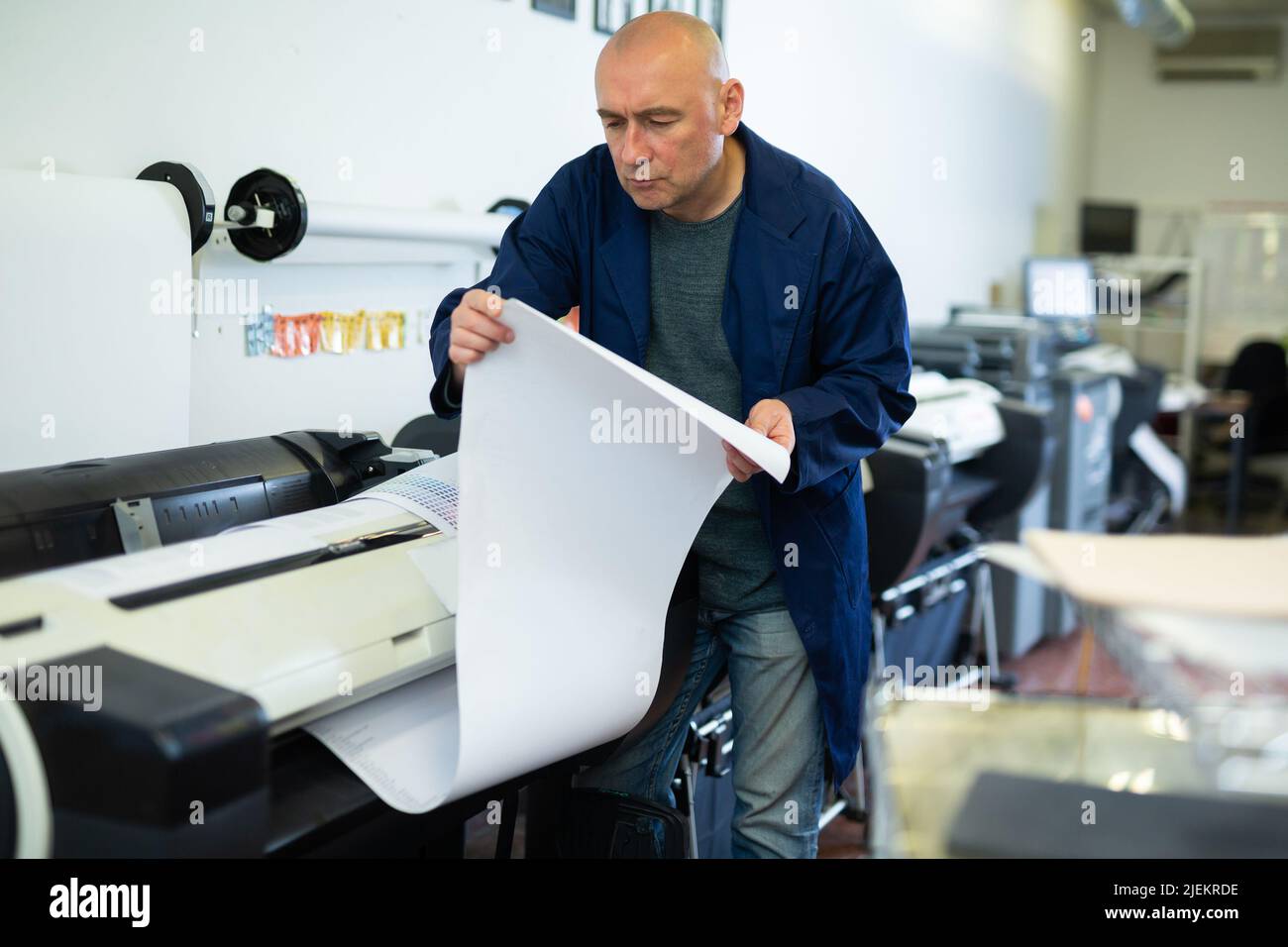 Man working in publishing facility Stock Photo