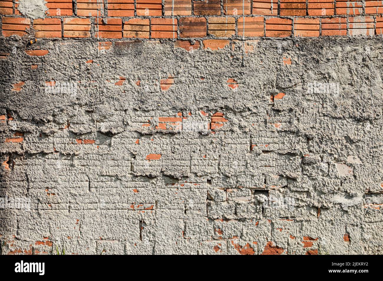 Wall mute with plaster and some exposed bricks, with signs of time