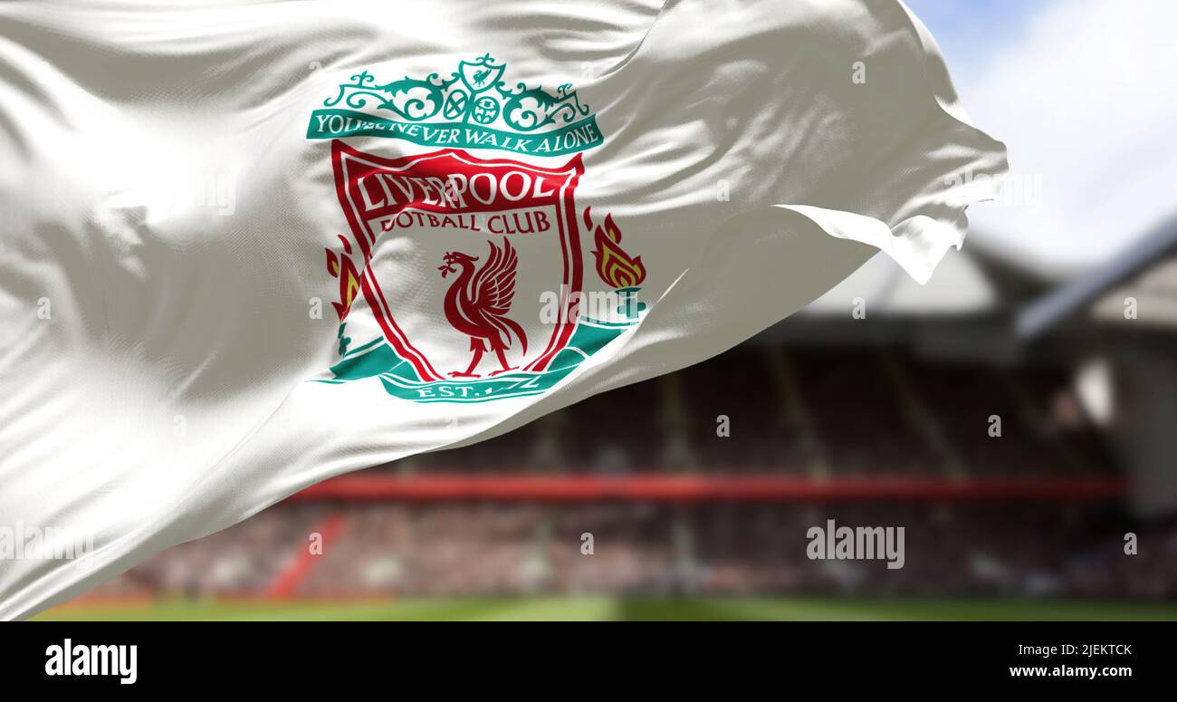 Liverpool, UK, May 2022: The flag of Liverpool Football Club waving in the wind with Anfield stadium blurred in the background. Liverpool is a profess Stock Photo