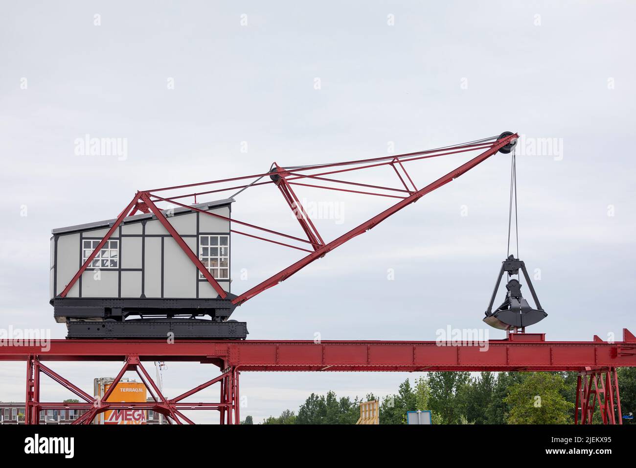 Old crane at former factory along the Helmond canal in the Netherlands Stock Photo