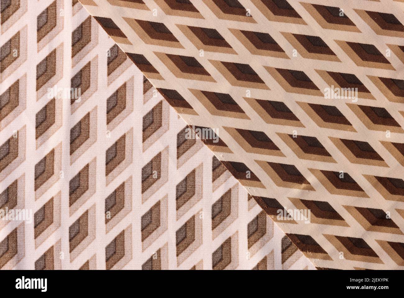 Fabric is cotton beige brown in rhombuses closeup Stock Photo