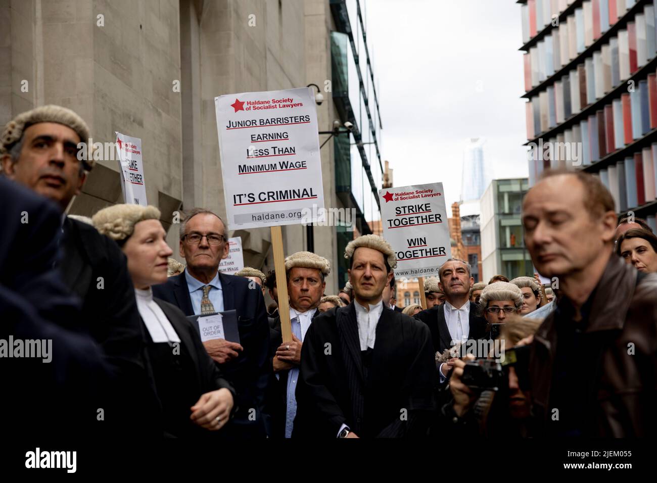 a-group-of-junior-criminal-barristers-hold-signs-outside-the-old-bailey