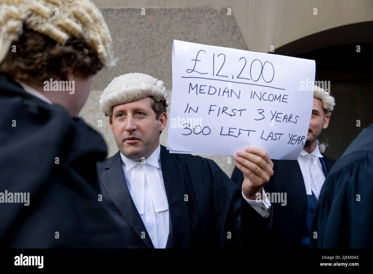 a-junior-criminal-barristers-holds-sign-outside-the-old-bailey