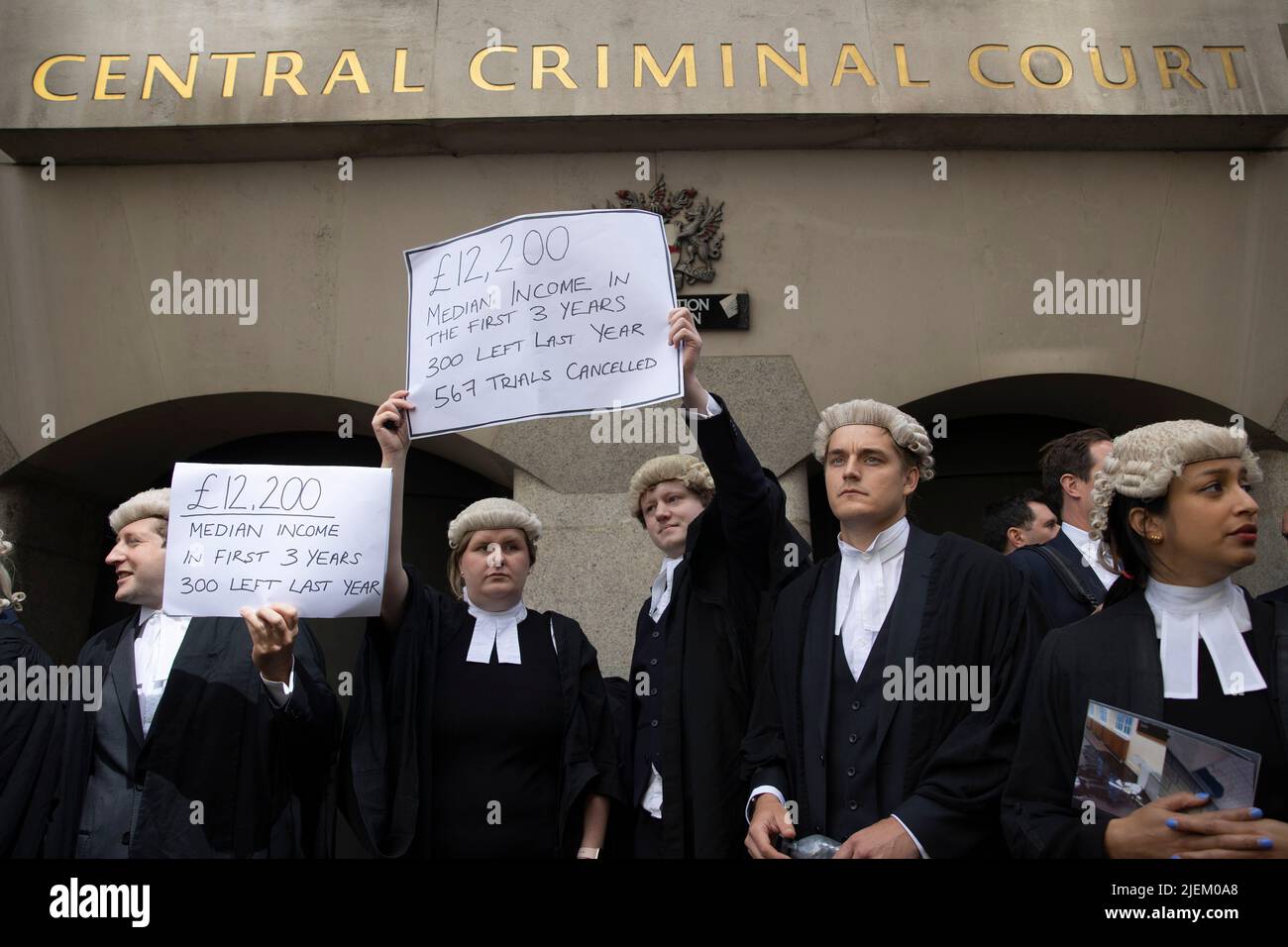 a-group-of-junior-criminal-barristers-hold-placards-outside-the-old