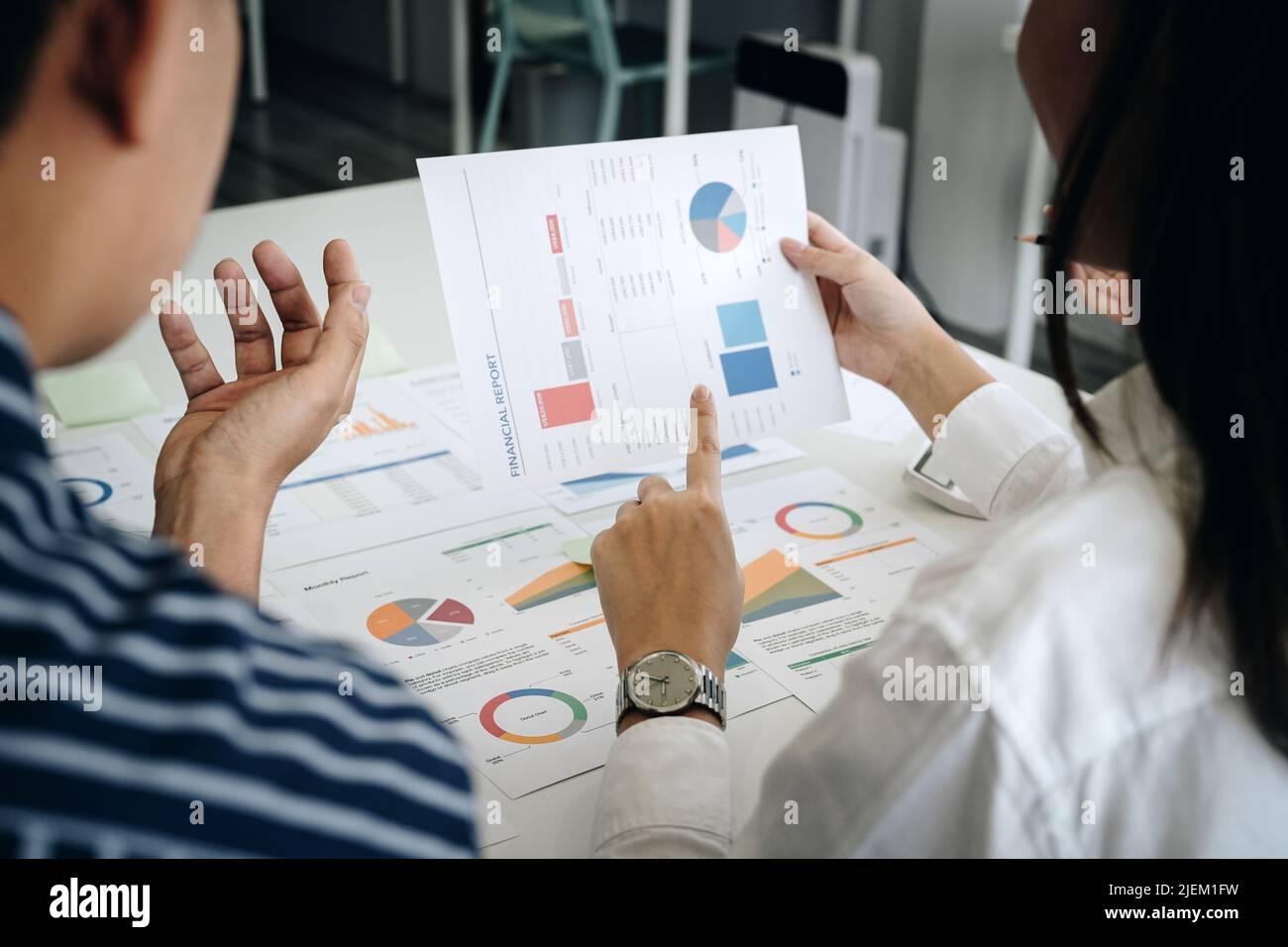 Business adviser analyzing financial figures denoting the progress in the work of the company Stock Photo