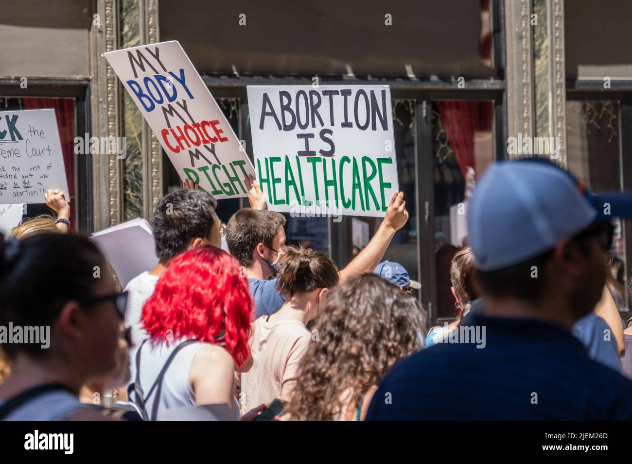 Protests holding pro-abortion signs at demonstration in response to the Supreme Court ruling overturning Roe v. Wade. Stock Photo