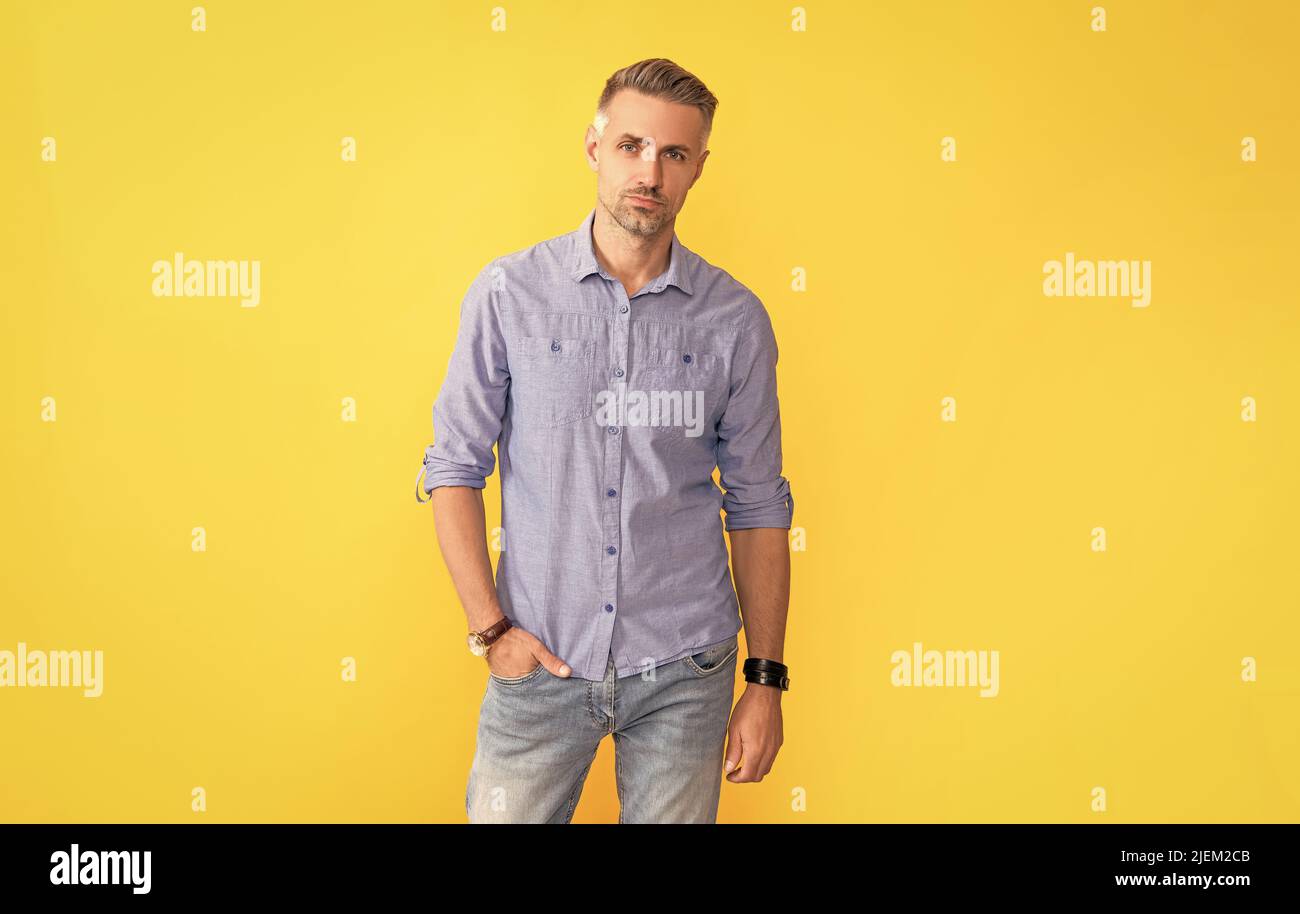 mature man with wrist watch on yellow background, fashion accessory Stock Photo