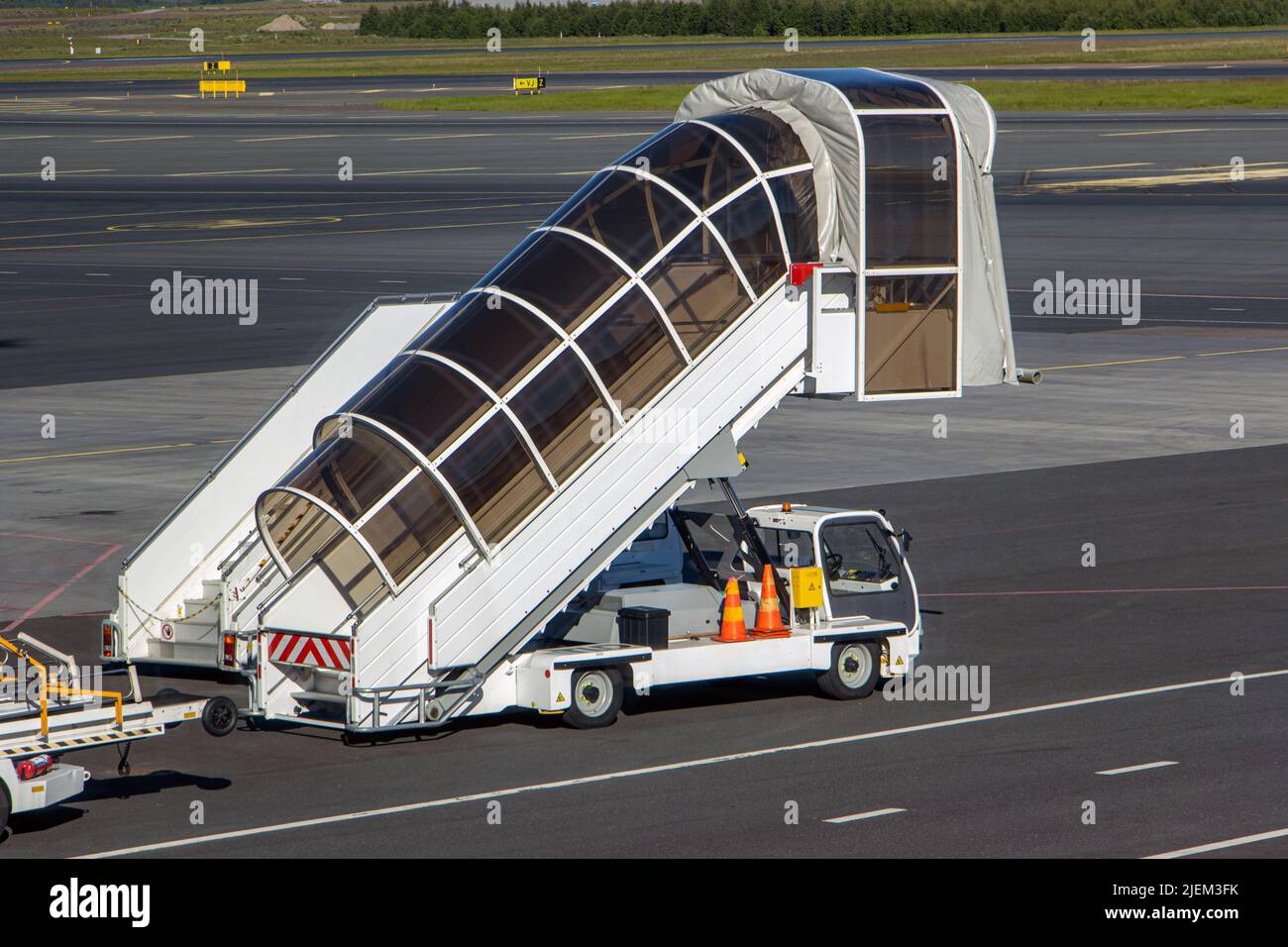 Mobile stairs for boarding and alighting passengers parked at the airport Stock Photo