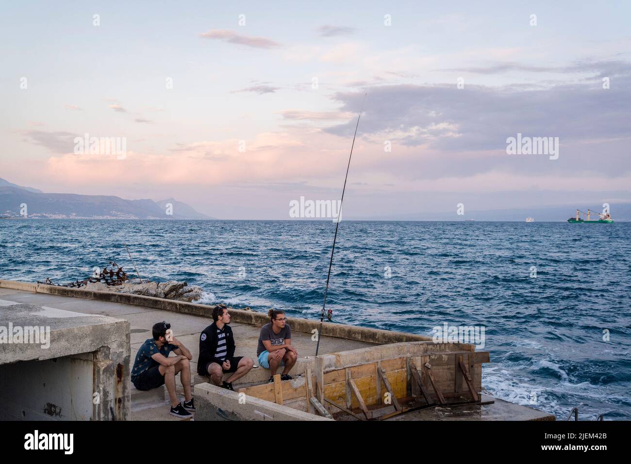 three anglers fishing in sea, Split, Croatia Stock Photo