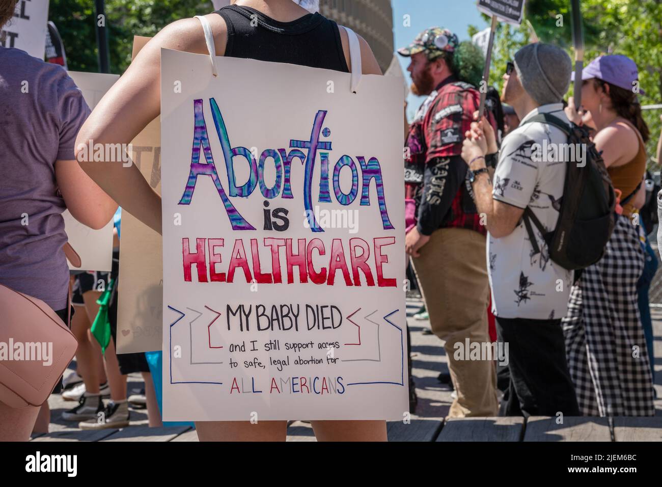 Protests holding pro-abortion signs at demonstration in response to the Supreme Court ruling overturning Roe v. Wade at the Massachusetts State House Stock Photo