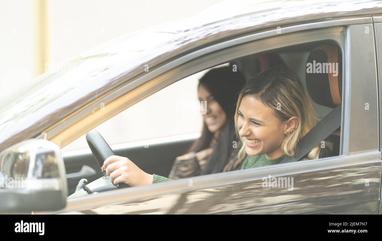 Two Young women smiling in a car enjoying a road tripping concept best ...