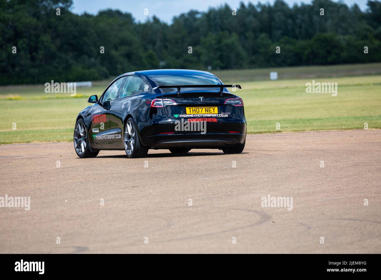 A Tesla Demonstrator car on the track at Bicester Aerodrome Stock Photo