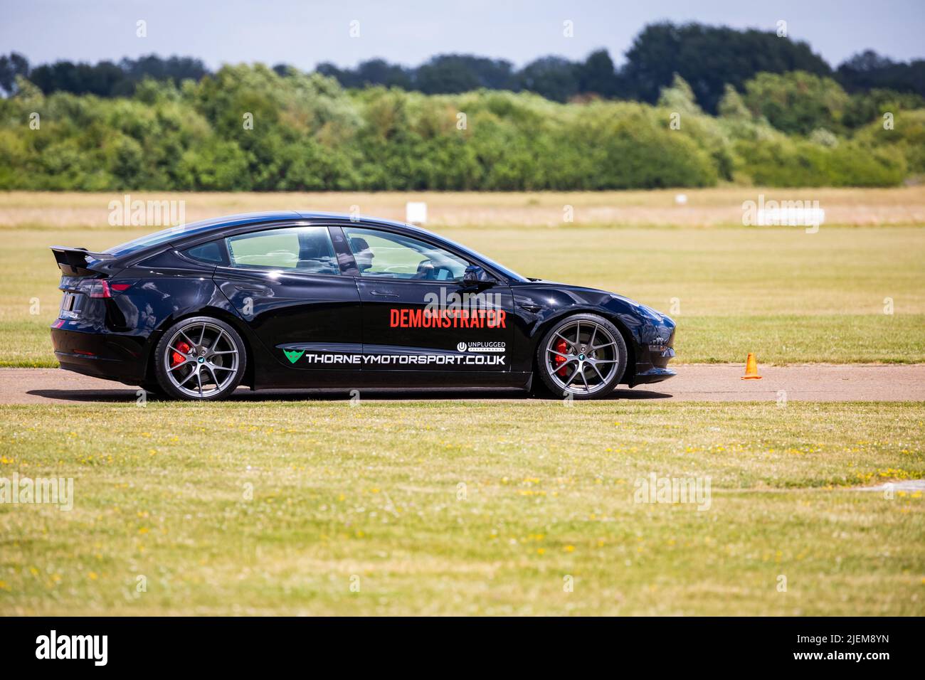 A Tesla Demonstrator car on the track at Bicester Aerodrome Stock Photo