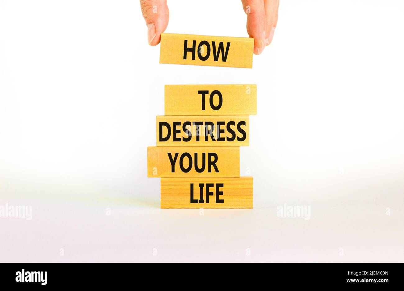 Destress your life symbol. Concept words How to destress your life on wooden blocks. Doctor hand. Beautiful white background. Psychological business a Stock Photo